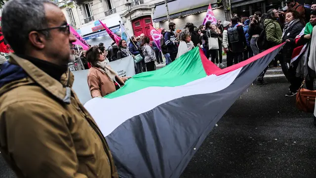 epa11291867 Protesters carry a Palestinian flag during the 'March against racism islamophobia and for the protection of all the children' in the streets of Paris, France, 21 April 2024. The march had previously been banned by the prefecture on the grounds that it could provoke major disturbances, a decision overturned by the courts. EPA/TERESA SUAREZ