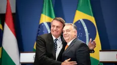 epa09766532 A handout photo made available by the Hungarian Prime Minister's Press Office shows Hungarian Prime Minister Viktor Orban (R) and Brazilian President Jair Bolsonaro reacting after a joint press conference following their meeting at the Hungarian PM's office in Budapest, Hungary, 17 February 2022. EPA/Vivien Cher Benko HANDOUT HANDOUT EDITORIAL USE ONLY/NO SALES