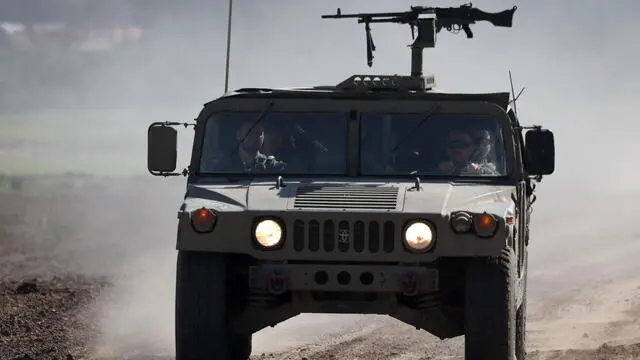 epa11103140 Israeli soldiers aboard military vehicles transit an area near the border with southern Gaza, at an undisclosed location in southern Israel, 25 January 2024. More than 25,700 Palestinians and at least 1,330 Israelis have been killed, according to the Palestinian Health Ministry and the Israel Defense Forces (IDF), since Hamas militants launched an attack against Israel from the Gaza Strip on 07 October 2023, and the Israeli operations in Gaza and the West Bank which followed it. The Israeli military stated on 25 January that its troops have conducted 'targeted raids on military sites' in the Al Amal area in Khan Yunis, southern Gaza. EPA/ATEF SAFADI