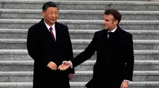 epa10561182 French President Emmanuel Macron (R) shakes hands with Chinese President Xi Jinping (L) during a welcome ceremony held outside the Great Hall of the People in Beijing, China, 06 April 2023. EPA/Ng Han Guan / POOL