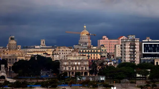 epa11239724 Dark clouds avbove the skyline of downtown during a rainy day in Havana, Cuba, 23 March 2024. Intense rains that have affected the western region of Cuba since 22 March have left 270,000 residents without electricity service, 26 total landslides in Havana alone and some 762 people self-evacuated in relatives' homes, the authorities of the Caribbean country reported. EPA/Ernesto Mastrascusa