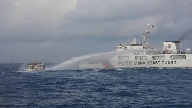 epa11022316 A handout picture made available by the Philippine Coast Guard (PCG) shows a Chinese Coast Guard ship (R) firing water cannon on Philippine Navy operated supply boat (M/L Kalayaan) (L) in the disputed South China Sea, Philippines, 10 December 2023 (issued on 11 December 2023). According to a report from the Philippine Coast Guard (PCG), on 10 December, Chinese coastguard ships fired water cannons and rammed one of the Philippine resupply vessels that suffered serious engine damage during a resupply mission in the disputed South China sea. EPA/Philippine Coast Guard / HANDOUT HANDOUT EDITORIAL USE ONLY/NO SALES HANDOUT EDITORIAL USE ONLY/NO SALES