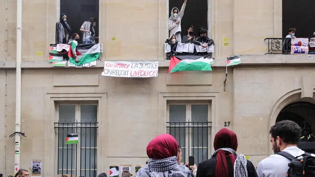 epaselect epa11303015 Students who occupied the Institut d'etudes politiques (Sciences Po Paris) display a banner reading 'We ask for justice, we get the police' during a demonstration to support the Palestinian people in Paris, France, 26 April 2024. A dozen students remain mobilized in support of the Palestinians by occupying a building at Sciences Po Paris since the evening of 25 April 2024, the day after police evacuated another of the school's sites, following actions taken at several universities in the United States in support of the Palestinian people. EPA/TERESA SUAREZ