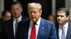 epa11310107 Former US President Donald Trump (C) arrives for his criminal trial at the New York State Supreme Court in New York, New York, USA, 30 April 2024. Trump is facing 34 felony counts of falsifying business records related to payments made to adult film star Stormy Daniels during his 2016 presidential campaign. EPA/JUSTIN LANE