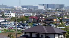 epa11287844 View of the industrial zone in the background at the town of Aikawa, Kanagawa Prefecture, near Tokyo, Japan, 16 April 2024 (issued 19 April 2024). Some 50 kilometers separate Tokyo from a small city whose rate of foreign residents is three times the national average and which, with foreigners from up to 45 countries, shows the most diverse face of Japan and the paradigm shift that the country is undergoing. It is Aikawa, a municipality of traditional Japanese houses and factories surrounded by mountains and with the highest proportion of foreign residents in Kanagawa Prefecture, which is also home to international cities such as the large Yokohama, Japan's second-largest city. Of the 39,427 inhabitants of Aikawa, 8.44 percent are foreigners, a percentage much higher than the national statistic (2.7 percent) in which Peruvian nationality predominates, followed by Vietnamese, Filipino and Brazilian. EPA/FRANCK ROBICHON