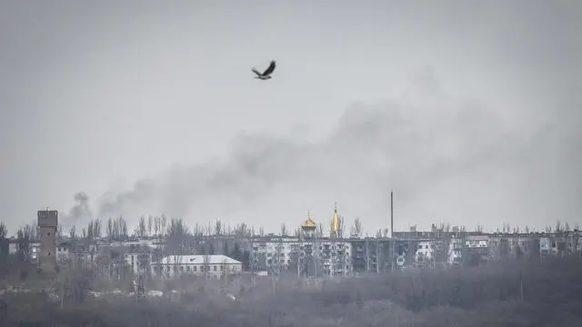 epa10563659 A bird flies above smoke after the shelling of Chasiv Yar town, near Bakhmut, Donetsk region, Ukraine, 07 April 2023. Russian troops entered Ukrainian territory on 24 February 2022, starting a conflict that has provoked destruction and a humanitarian crisis. EPA/OLEG PETRASYUK