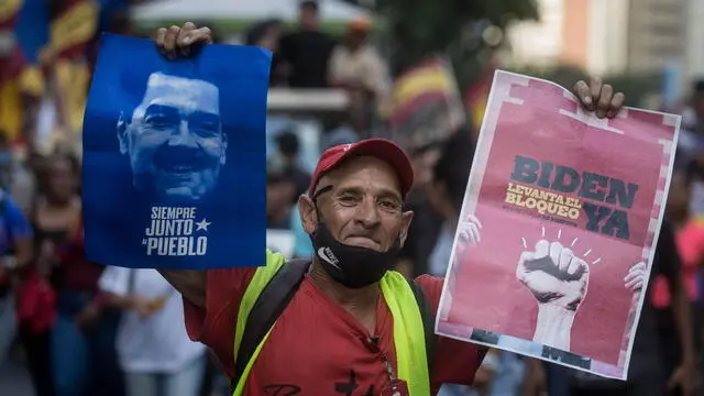 epa11313542 A supporter of the president of Venezuela, Nicolas Maduro, participates during a demonstration in support of the president's government, in Caracas, Venezuela, 01 May 2024. Maduro reported that Venezuela closed the first quarter of the year with partial losses of more than two million dollars (about 1,866 million euros) in its income as a consequence of US sanctions which resumed in April. EPA/Miguel Gutierrez