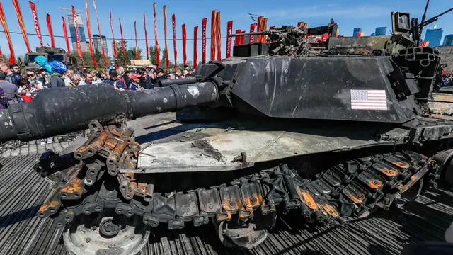 epa11312173 People look at a US-made main battle tank M1 Abrams captured by Russian troops during Russia's 'special military operation' in Ukraine, at an exhibition on the Poklonnaya Hill in Moscow, 01 May 2024. The exhibition, organized by the Russian Defense Ministry, opened on 01 May and will last for a month. The display features more than 30 samples of equipment made in several countries, including the USA, Britain, Germany, France, Turkey, Sweden, Czech Republic, South Africa, Finland, Australia, Austria and Ukraine. On 24 February 2022, Russian troops entered Ukrainian territory in what the Russian president declared a 'special military operation', starting an armed conflict that has provoked destruction and a humanitarian crisis. EPA/YURI KOCHETKOV