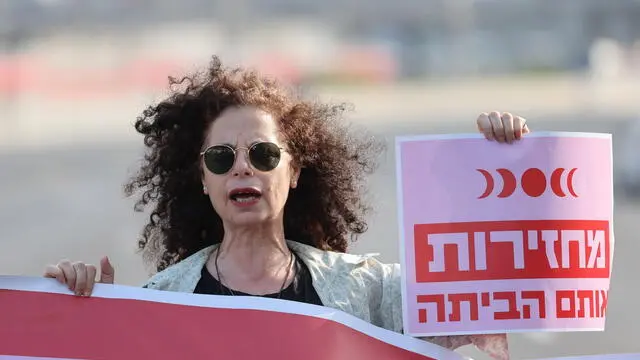 epa11313773 A demonstrator holds up a banner reading 'Bring them home' as families of Israeli hostages held by Hamas in Gaza and their supporters block the Ayalon Highway during a protest calling on the Israeli war cabinet to make a deal for the release of the hostages, in Tel Aviv, Israel, 02 May 2024. According to the Israeli military, 133 Israelis, who were abducted and taken to the Gaza Strip during the 07 October 2023 attacks by Hamas, remain in captivity. Rallies in Israel have been critical of the government's handling of the crisis, demanding the immediate release of all hostages. EPA/ABIR SULTAN