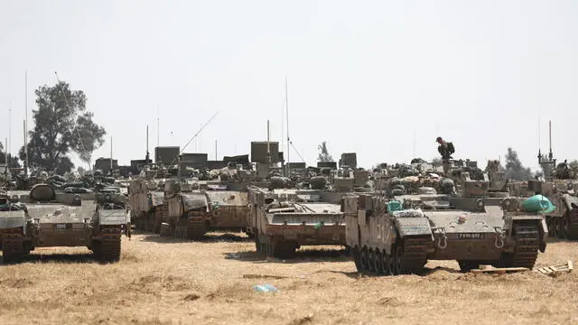 epa11312274 Israeli soldiers with military vehicles gather at a position on the southern Israeli border with the Gaza Strip, near the Palestinian city of Rafah, 01 May 2024. More than 34,300 Palestinians and over 1,455 Israelis have been killed, according to the Palestinian Health Ministry and the Israel Defense Forces (IDF), since Hamas militants launched an attack against Israel from the Gaza Strip on 07 October 2023, and the Israeli operations in Gaza and the West Bank which followed it. EPA/ATEF SAFADI