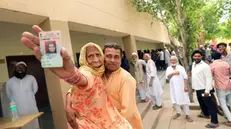 epa11301791 Indian voter Asgri, 90, shows her voter ID after casting her vote in Ghaziabad, Uttar Pradesh, India, 26 April 2024. Voting for the second phase of general elections started in various states in India. General elections in India will be held over seven phases between 19 April and 01 June 2024 for India's 545-member lower house of parliament, or Lok Sabha, which are held every five years in which about 968 million people are eligible to vote. EPA/HARISH TYAGI