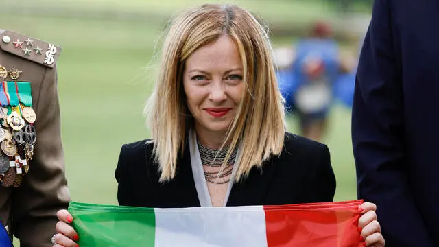 Italian Prime Minister Giorgia Meloni poses with the 'Tricolore' (the Italian flag) during an Army Celebration for the 163th anniversary of the establishment of the Armed Force, Rome, Italy 3 May 2024. ANSA/FABIO FRUSTACI