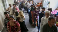 epa11323978 Indian voters wait in a long queue to cast their votes at a polling station during the third phase of the general elections in Ahmedabad, Gujarat, western India, 07 May 2024. The Indian general elections are held in seven phases between 19 April and 01 June 2024, with the results announced on 04 June 2024. EPA/DIVYAKANT SOLANKI