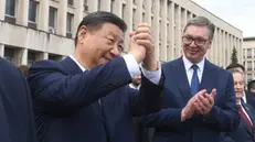 epa11326290 A handout photo made available by the Serbian Presidency shows Chinese President Xi Jinping (L) waving to well-wishers as the Serbian President Aleksandar Vucic (R) applauds in Belgrade, Serbia, 08 May 2024. The Chinese president is on a two-day official visit to Serbia. EPA/DIMITRIJE GOLL / SERBIAN PRESIDENCY / HANDOUT HANDOUT EDITORIAL USE ONLY/NO SALES HANDOUT EDITORIAL USE ONLY/NO SALES