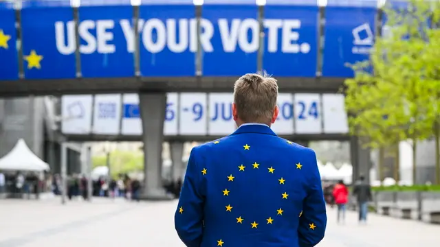 epa11317716 A man wearing a suit of EU flag attends the open days of European institutions on 'Europe Day' in Brussels, Belgium, 04 May 2024. Thousands of visitors attended the Europe Day, an annual celebration of peace and unity in Europe, that falls this year a month ahead to the European elections to renew members of the European Parliament EPA/FREDERIC SIERAKOWSKI