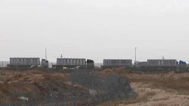 epa11300540 Humanitarian trucks carrying provisions waiting in line on the Egyptian side of the border near Kerem Shalom crossing at the southern Israeli border with the Gaza Strip, on 25 April 2024. Since 07 October 2023, up to 1.9 million people, or more than 85 percent of the population, have been displaced throughout the Gaza Strip, some more than once, according to the United Nations Relief and Works Agency for Palestine Refugees in the Near East (UNRWA), which added that most civilians in Gaza are in 'desperate need of humanitarian assistance and protection'. EPA/ATEF SAFADI