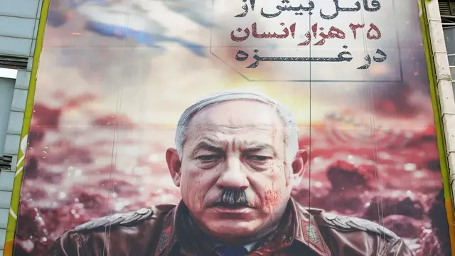 epa11334667 An anti-Israel billboard depicting Israeli Prime Minister Benjamin Netanyahu as Adolf Hitler and carrying a sentence that reads in Persian 'The murder of more than 35,000 humans in Gaza', in Tehran, Iran, 12 May 2024. Tension between Iran and Israel continues since Iran's Islamic Revolutionary Guards Corps (IRGC) launched drones and missiles towards Israel on 13 April 2024, following an airstrike on the Iranian embassy in Syria, which Iran claimed was conducted by Israel. Iranian state media reported that three aerial objects were destroyed by air defense systems over the central city of Isfahan in the early morning of 19 April 2024. EPA/ABEDIN TAHERKENAREH