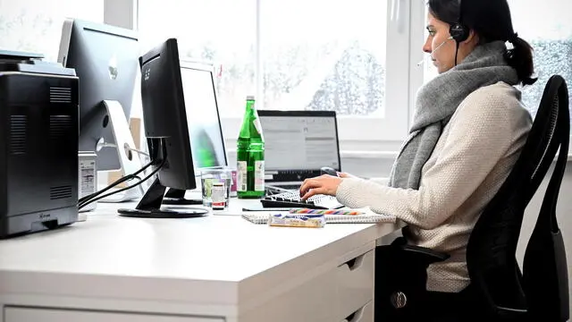 epa08933118 A woman with a headset sits in front of her computer in the study at home in Moenchengladbach, Germany, 12 January 2021. In view of the fact that the number of corona infections is not declining, politicians are calling for greater use to be made of working from home again. However, around 60 percent of employees in Germany are unable to work from home - often because their work involves a service to others, according to the German Institute for Economic Research (DIW). Other tasks, in turn, are linked to the respective jobs. Companies are already struggling to survive this pandemic. Throughout Germany, the number of cases of the COVID-19 disease caused by the SARS-CoV-2 coronavirus is still high. EPA/SASCHA STEINBACH