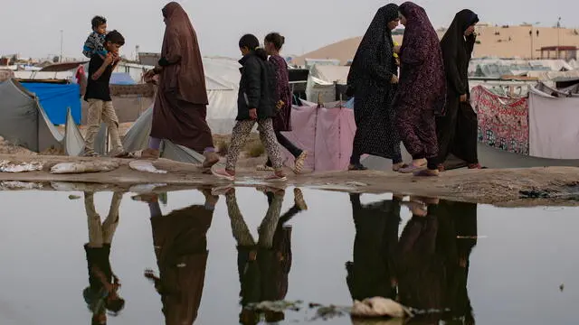 epa11303535 Palestinians walk next to a sewage spill near tents for internally displaced people at a temporary camp in Rafah camp, southern Gaza Strip, 26 April 2024. Since 07 October 2023, up to 1.7 million people, or more than 75 percent of the population, have been displaced throughout the Gaza Strip, some more than once, in search of safety, according to the United Nations Relief and Works Agency for Palestine Refugees in the Near East (UNRWA), which added that the Palestinian enclave is 'on the brink of famine', with 1.1 million people (half of its population) 'experiencing catastrophic food insecurity' due to the conflict and restrictions on humanitarian access. EPA/HAITHAM IMAD