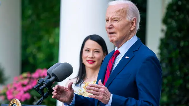epa11338145 US President Joe Biden, with US actor Lucy Liu, delivers remarks during a reception celebrating Asian American, Native Hawaiian, and Pacific Islander Heritage Month in the Rose Garden the White House in Washington, DC, USA, 13 May 2024. EPA/SHAWN THEW / POOL