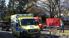 epa10511372 An ambulance in front of a villa that caught fire, in Yverdon-les-Bains, Switzerland, 09 March 2023. According to the Vaudois police, several bodies were found in a villa that caught fire after an explosion. EPA/JEAN-CHRISTOPHE BOTT