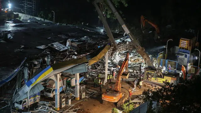 epa11337917 Members of the National Disaster Response Force (NDRF) and other rescuers undertake a rescue operation at A petrol station after a giant billboard fell on it in Mumbai, India, 14 May 2024. At least eight people were killed and more than 50 people injured after a giant billboard fell on a petrol station amid rain and gusty winds, in the Ghatkopar area of Mumbai. EPA/DIVYAKANT SOLANKI