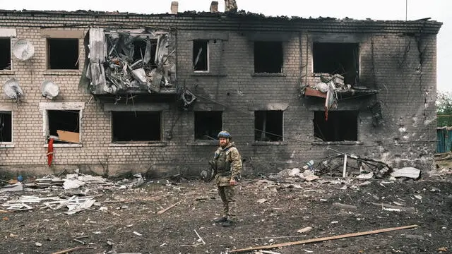 epa11336743 A Ukrainian police officer inspects a damaged building during the evacuation of local people from territories bordering Russia, in the city of Vovchansk, Kharkiv region, northeastern Ukraine, 13 May 2024, amid the Russian invasion. More than 4,000 residents from settlements in areas of the Kharkiv region bordering Russia have been evacuated as 'hostilities intensified', the head of the Kharkiv Military Administration Oleg Synegubov wrote on telegram. The evacuations follow a cross-border offensive by Russian forces, who claimed the capture of several villages in the region. Russian troops entered Ukrainian territory on 24 February 2022, starting a conflict that has provoked destruction and a humanitarian crisis. EPA/GEORGE IVANCHENKO