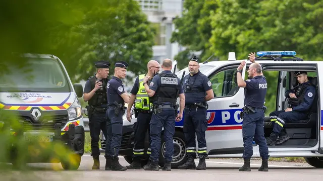 epa11339830 French policemen stand guard at the toll station of Incarville, near Rouen, in the North of France, where gunmen ambushed a prison van on 14 May 2024, killing two prison guards and helping a prisoner to escape. Three other prison guards were severely wounded, according to Justice minister Eric Dupond-Moretti. A major police manhunt has been launched to find the gunmen and the escaped prisoner, identified as a 30-year-old drug dealer from northern France, according to the Paris prosecutor's office. EPA/CHRISTOPHE PETIT TESSON