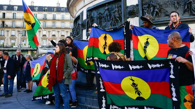 epa11346098 Protesters hold Kanak flags as they participate in a rally called by Caledonian activists in solidarity with Kanak people, at Place de la Republique in Paris, France, 16 May 2024. The French territory of New Caledonia has experienced three nights of clashes in response to a reform to electoral procedures, which the indigenous Kanak population believes will diminish their vote. France has declared a state of emergency and deployed its military to the territory's ports and international airport in response to the unrest, which has resulted in at least four deaths and hundreds of wounded. EPA/MOHAMMED BADRA