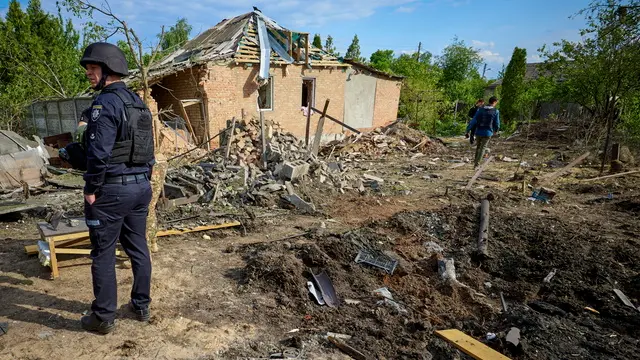 epaselect epa11351157 A local man stays near the site of a glide bomb shelling of a private building in Kharkiv, Ukraine, 18 May 2024, amid the Russian invasion. At least five people were injured as the result of shelling of a residential area according to the report of the head of the Kharkiv Military Administration Oleg Synegubov. Russian troops entered Ukraine in February 2022 starting a conflict that has provoked destruction and a humanitarian crisis. EPA/SERGEY KOZLOV