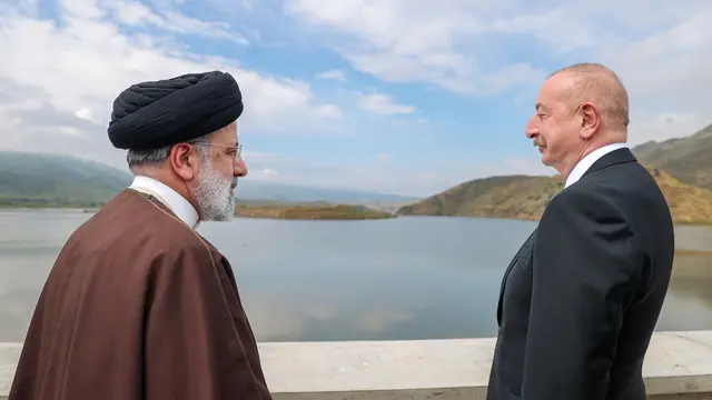 epa11352290 A handout photo made available by the Iranian presidential office shows, Iranian President Ebrahim Raisi (L) and Azerbaijan President Ilham Aliyev (R) conversing during an inauguration ceremony of the joint Iran-Azerbaijan-constructed Qiz-Qalasi dam at the Aras River at the Iran and Azerbaijan shared border in north-western Iran, 19 May 2024. EPA/IRANIAN PRESIDENTIAL OFFICE / HANDOUT HANDOUT EDITORIAL USE ONLY/NO SALES HANDOUT EDITORIAL USE ONLY/NO SALES