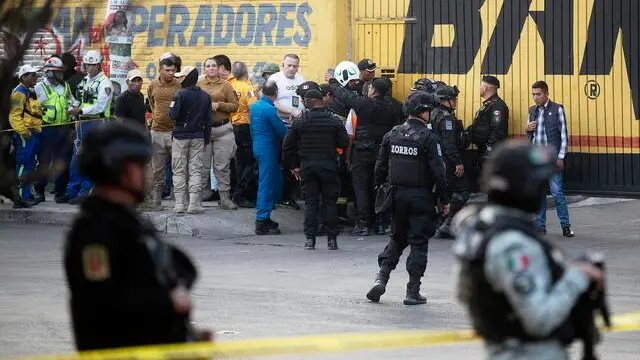 epa11279323 Police officers guard the scene at a automotive workshop where a helicopter crashed, in CoyoacÃ¡n, Mexico City, Mexico, 14 April 2024. Three deaths, presumably the pilot and two crew members, were caused by the fall of a private helicopter in the CoyoacÃ¡n neighborhood south of Mexico City, capital government authorities reported. EPA/Isaac Esquivel