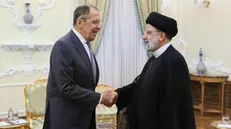 epa10934850 A handout picture made available by Russian Foreign ministry press service shows Iranian President Ebrahim Raisi (R) shakes hands with Russian Foreign Minister Sergei Lavrov (L), during their meeting following Second regional 3+3 regional meeting, in Tehran, Iran, 23 October 2023. Iran holds the meeting aiming to solve tension between Azerbaijan and Armenia. EPA/RUSSIAN FOREIGN MINISTRY PRESS SERVICE HANDOUT HANDOUT EDITORIAL USE ONLY/NO SALES HANDOUT EDITORIAL USE ONLY/NO SALES