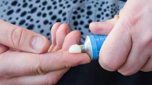 Patient squeezes out of aluminum tubes ointment with medicinal substance on finger. Photo of use of drug in form of ointments for application on skin and treating skin diseases, psoriasis, acne