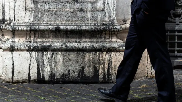 epa11355915 A person stands in front of the columns outside the Italian Ministry of Justice after Last Generation (Ultima Generazione) climate activists smeared it with black paint, in Rome, Italy, 20 May 2024. A group of six Last Generation climate activists were stopped by police and taken to a police station for questioning after they painted in black the columns outside the Ministry of Justice in Rome. EPA/ANGELO CARCONI