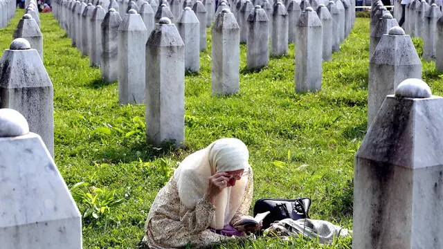 epa10739023 A Bosnian Muslim woman prays during a funeral ceremony for thirty newly-identified Bosnian Muslim victims, at the Potocari Memorial Center and Cemetery, in Srebrenica, Bosnia and Herzegovina, 11 July 2023.The burial was part of a memorial ceremony to mark the 28th anniversary of the Srebrenica genocide, considered the worst atrocity of Bosnia's 1992-95 war. More than 8,000 Muslim men and boys were executed in the 1995 killing spree after Bosnian Serb forces overran the town. EPA/FEHIM DEMIR
