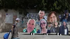 epa11362204 A woman walks by pictures of Israeli hostages held by Hamas in Gaza outside the residence of the Israeli Prime Minister Benjamin Netanyahu, in Jerusalem, 23 May 2024. According to the Israeli defense forces, 128 Israelis hostages are still held by Hamas in Gaza. More than 35,000 Palestinians and over 1,400 Israelis have been killed, according to the Palestinian Health Ministry and the Israel Defense Forces (IDF), since Hamas militants launched an attack against Israel from the Gaza Strip on 07 October 2023, and the Israeli operations in Gaza and the West Bank which followed it. EPA/ABIR SULTAN