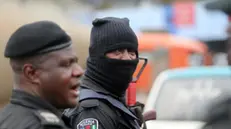 epa09534457 A policeman is seen wearing a hood during a memorial protest for a military attack at the Lekki tollgate in Lagos, Nigeria, 20 October 2021. Police disperse youths who held a memorial protest in Lagos to commemorate a military attack during the protest against police brutality on 20 October 2020. EPA/AKINTUNDE AKINLEYE