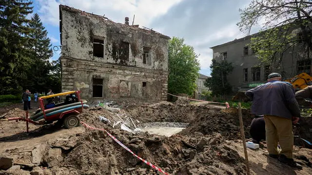 epa11304557 Communal workers operate at the site of a rocket attack on a regional psychiatric hospital in Kharkiv, northeastern Ukraine, 27 April 2024. According to the Regional Prosecutor's Office Russia hit the city with two missiles of the S-300 type from the territory of the Belgorod region. In total, Russia used 34 air, ground, and sea-based missiles for the night time shelling of Ukraine as Air Force Command of UA Armed Forces reported. 21 were shot down by Ukrainian troops. As a result of the attack, the enterprise equipment of the four thermal power plants was seriously damaged according to the DTEK Group energy holding report. EPA/SERGEY KOZLOV 50901