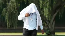 epa11302757 A man covers himself to avoid the sun during a hot summer day in New Delhi, India, 26 April 2024. Many parts of the country are reeling under heat conditions with capital of the country, New Delhi already touching the 39 degrees Celsius mark. EPA/RAJAT GUPTA