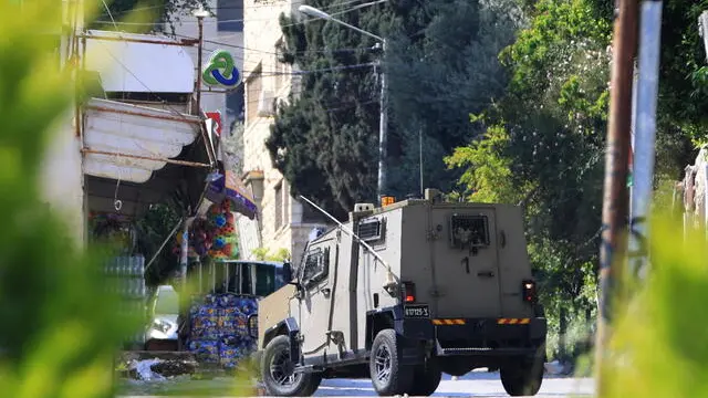 epa11279473 Israeli troops during a raid in the West Bank city of Nablus, 15 April 2024. According to the Palestinian Health Ministry, at least one Palestinian was killed and five others were wounded in the raid. EPA/ALAA BADARNEH