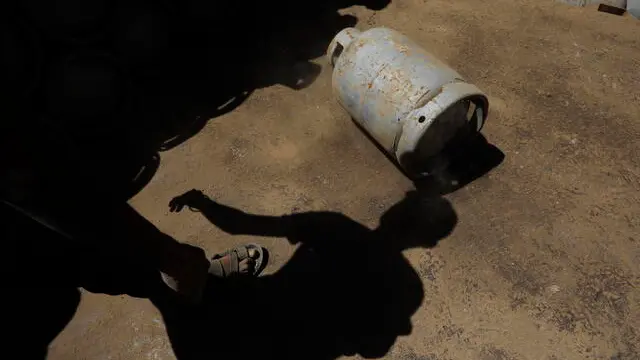 epa11183532 The shadow of a worker transferring cooking gas cylinders that are being distributed for free to the families of slain Houthi fighters, in Sanaa, Yemen, 26 February 2024. Yemen's Houthis have distributed more than 40,000 cooking gas cylinders for free to the families of slain Houthi fighters, amid rising tensions between the Houthis and the US-led coalition due to Houthis' attacks on vessels in the Red Sea and the Gulf of Aden, according to Houthi news outlets. The US-led coalition seeks to degrade the Houthis' abilities to attack commercial shipping vessels amid high tensions in the Middle East. EPA/YAHYA ARHAB