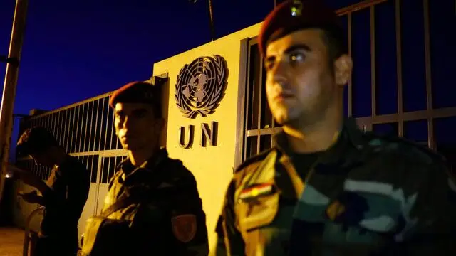 epa06271625 Soldiers stand in front of the UN building as people hold sad face emojis to announce a campaign reacting to the unfortunate response from the international community towards the Blockade on Kurdistan, infront of United Nations Headquarters in Erbil, Capital of the Kurdistan Region, in Iraq, 17 October 2017. Following the independence referendum held on 25 September 2017, the Iraqi government took measures against the region of Kurdistan, including capturing Kirkuk city from the Kurdish Peshmerga troops. EPA/GAILAN HAJI