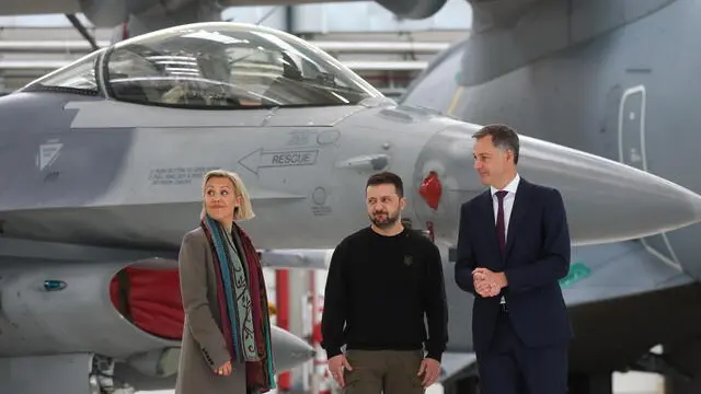 epaselect epa11375131 Ukraine's President Volodymyr Zelensky (C) stands with Belgian Defense Minister Ludivine Dedonder (L) and Belgian Prime Minister Alexander De Croo (R) ahead of a meeting with pilots, Belgian instructors and maintenance team of F-16 fighter aircraft at the Melsbroek military airport, in Brussels, Belgium, 28 May 2024. Zelensky visits Belgium to ink the latest in a string of security accords with Western allies. The two leaders discussed, among other things, Belgium's military support to Ukraine and the signing of a bilateral security agreement, including the supply of F-16 fighter jets as part of the security agreement. EPA/OLIVIER HOSLET