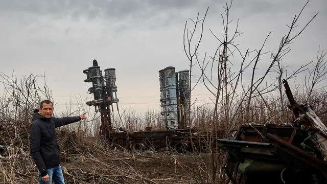 epaselect epa11228536 Alexander, the leader of a local community, shows burnt S300 missile launchers outside a village some 10 km from the frontline, near Kupiansk, Kharkiv region, northeastern Ukraine, 18 March 2024, amid the Russian invasion. About 3,000 people live in 13 villages of the Kurylivska Community of the Kupiansk district, where more than 12,000 people lived before the war. The remaining residents refuse to leave their homes as they have nowhere else to go and no financial resources. Kupiansk, a once-occupied town, has seen increased assaults by Russia in recent months. Russian troops entered Ukraine in February 2022 starting a conflict that has provoked destruction and a humanitarian crisis. EPA/SERGEY KOZLOV