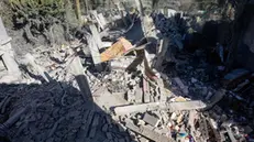 epa11199670 A view of destruction as Palestinians (R, back) search for missing people under the rubble of their home after an Israeli air strike, in Khan Yunis refugee camp, southern Gaza Strip, 05 March 2024. More than 30,500 Palestinians and over 1,300 Israelis have been killed, according to the Palestinian Health Ministry and the Israel Defense Forces (IDF), since Hamas militants launched an attack against Israel from the Gaza Strip on 07 October 2023, and the Israeli operations in Gaza and the West Bank which followed it. The Israeli military stated on 05 March that its troops continued to operate in the Hamad area in western Khan Yunis conducting 'targets raids' on Hamas infrastructure. EPA/HAITHAM IMAD