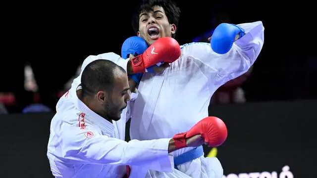 epa10948161 Abdalla Abdelaziz (L) of Egypt and Abdalla Hammad of Jordan fight in the final match of men's team kumite competition the 26th WKF World Karate Championships in Papp Laszlo Sports Arena in Budapest, Hungary, 29 October 2023. EPA/TAMAS KOVACS HUNGARY OUT