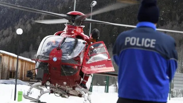 epa06660948 (FILE) A police officer looking at an Air Zermatt helicopte landing after research on the area of the avalanche site where five hikers carried away yesterday by an avalanche in Obers Taelli over the Fiescheralp, in Fiesch, Switzerland, 01 April 2018 (reissued 11 April 2018). Authorities in Switzerland and Italy are searching for the German billionaire who has been missing in the Alps since 07 April 2018. Due to heavy snowfall, Zermatt can only be reached by air. Swiss authorities have closed roads and train service into the town of Zermatt amid a heightened risk of avalanches. EPA/JEAN-CHRISTOPHE BOTT