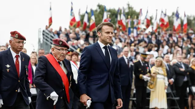 epa11391285 French President Emmanuel Macron and Achille Muller, 98, last survivor of the Free French Forces, attend a ceremony to pay homage to the Saint Marcel maquis, a force of French Resistance fighters during World War II and the French SAS (Special Air Service) paratroopers, in Plumelec, Brittany, north-western France, 05 June 2024. French President Macron launched the commemoration of the 80th anniversary of D-Day, the Normandy landings of Western Allied forces on 06 June 1944 that initiated the liberation of western Europe during World War II, by paying tribute to the French Resistance fighters. EPA/BENOIT TESSIER / POOL MAXPPP OUT