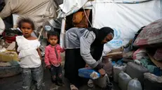 epa10541342 Yemeni children stand next to their grandmother at a makeshift camp for Internally Displaced Persons (IDPs) in Sana'a, Yemen, 23 March 2023 (issued 24 March 2023). More than 11 million children in Yemen require urgent humanitarian aid as they could face greater risks of malnutrition due to the consequences of eight years of the endless and crushing war in the Arab country, the United Nations Children's Agency (UNICEF) has warned. The protracted war in Yemen is referred to as the Saudi Arabia-Iran proxy conflict in which the warring parties have been militarily and politically backed by Saudi Arabia and Iran respectively since 2015. EPA/YAHYA ARHAB